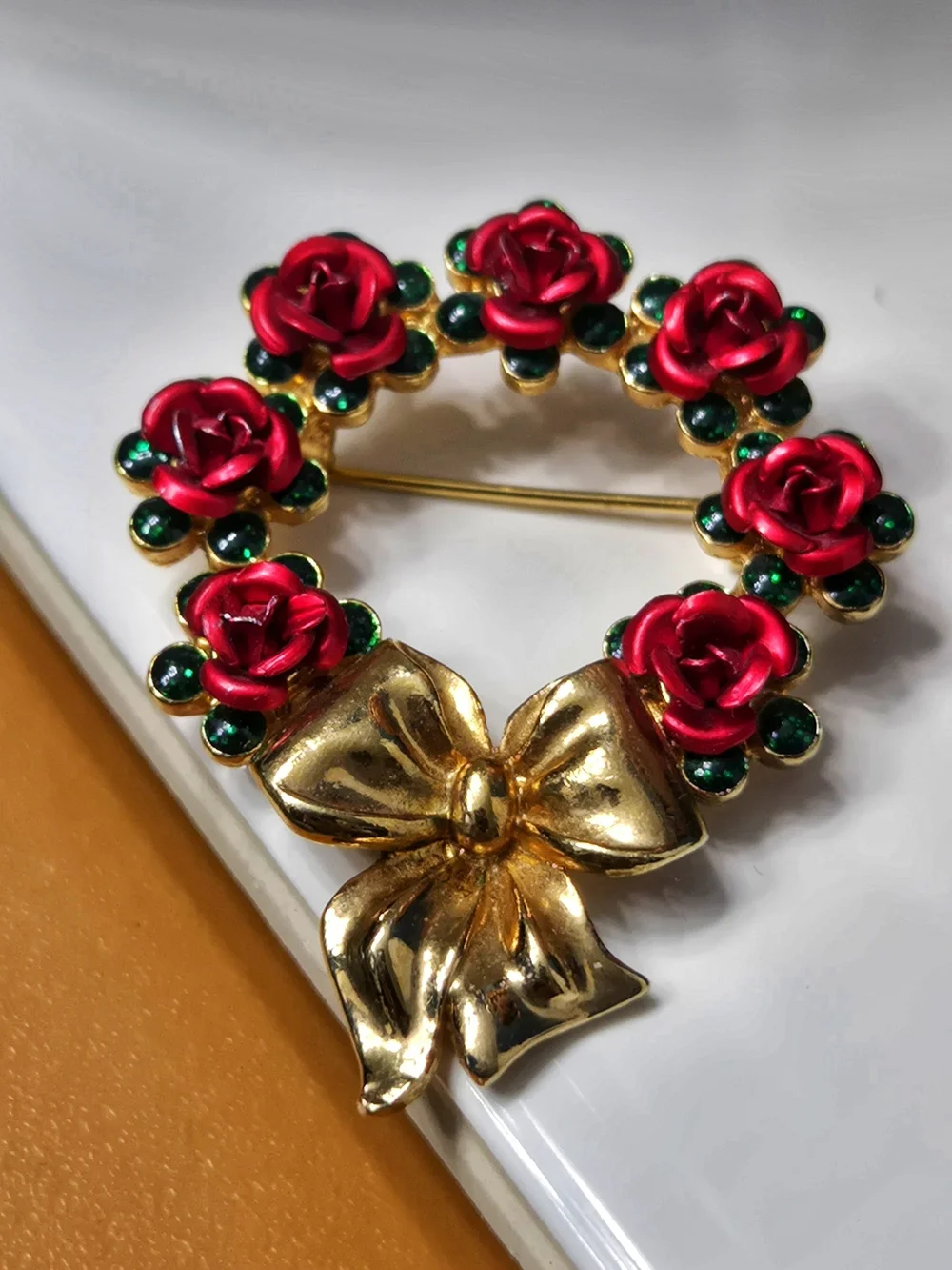 Avon Gold Bow Wreath Brooch with Red Roses and Green Accents